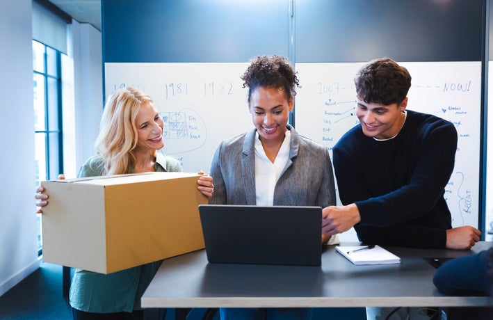 Women with packaging, talking to colleagues
