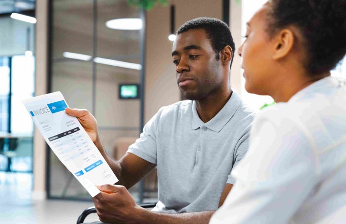 Two people discussing an invoice