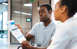 Two people discussing an invoice