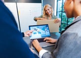 Women with packaging, laptop in foreground