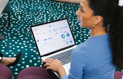A woman works on accounting on a laptop
