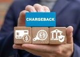 Person holding a block that reads 'chargeback'