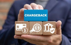 Person holding a block that reads 'chargeback'