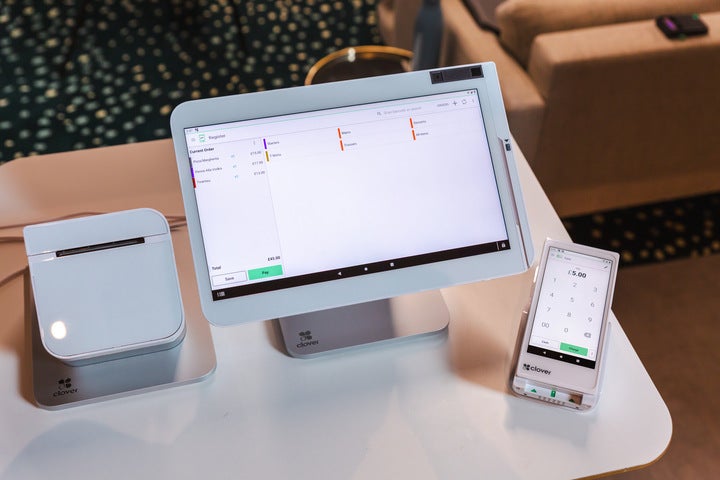 A close-up image of the Clover POS terminal, card reader and printer