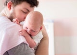 Man holding newborn baby