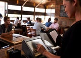 Restaurant staff member preparing a bill