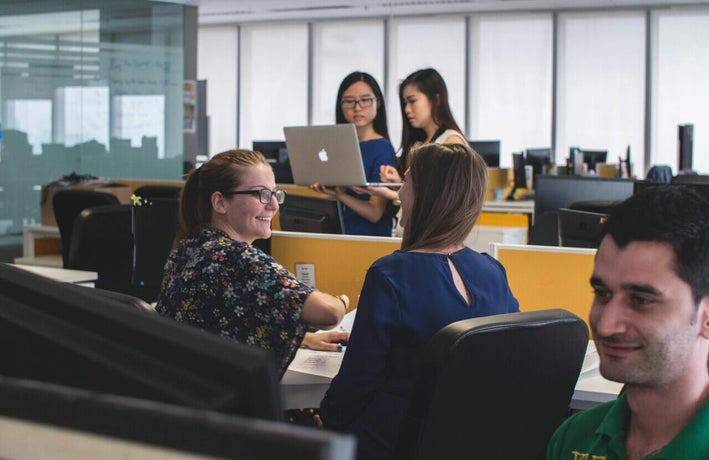 Employees chatting in a shared office space