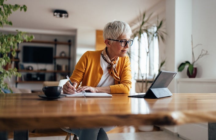 Senior businesswoman, working hard, from home office.